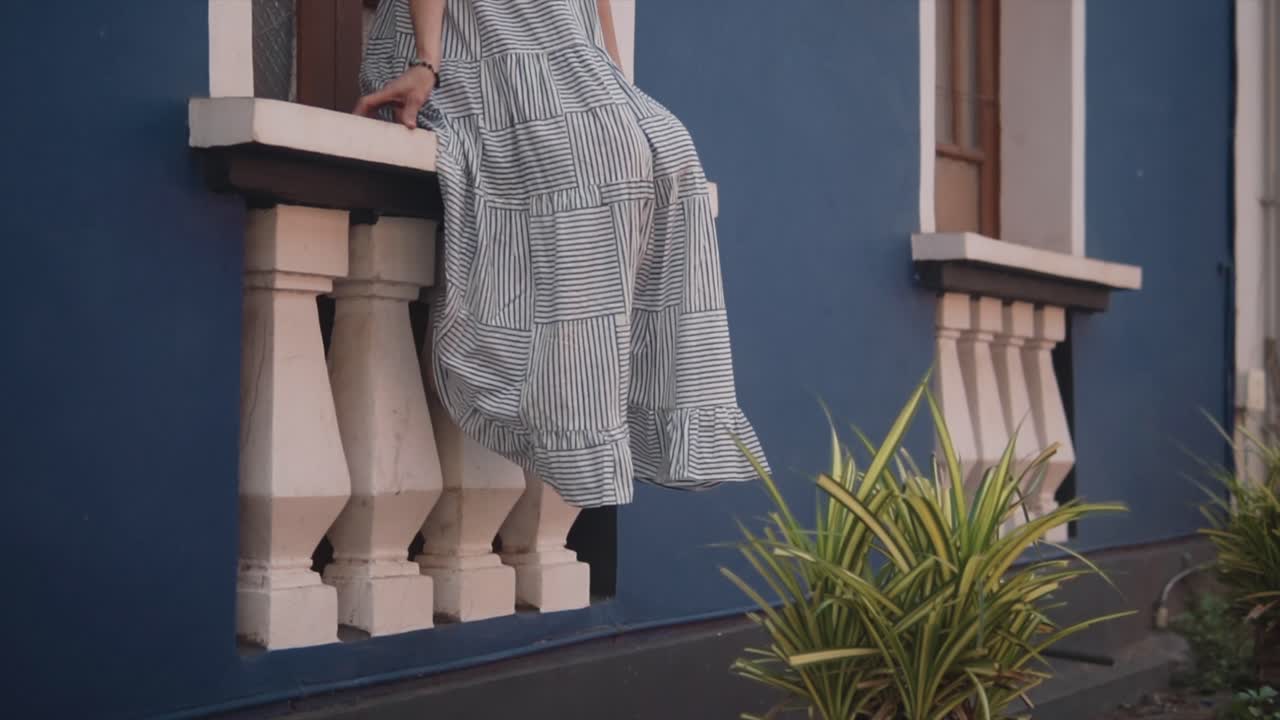 Women sitting on the side of the window shelf