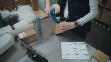 warehouse worker packing boxes