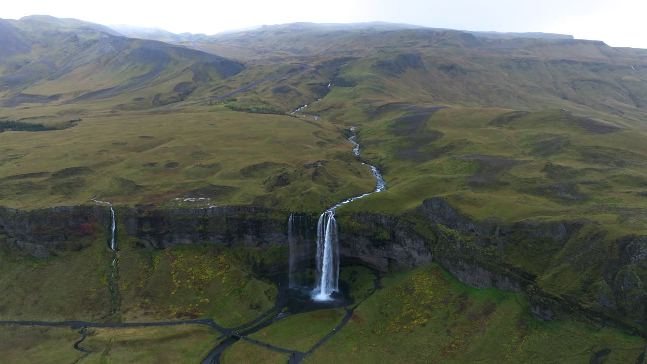 catarata de seljalandsfoss con paisaje verde en islandia
