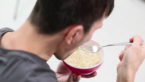 man eating noodles