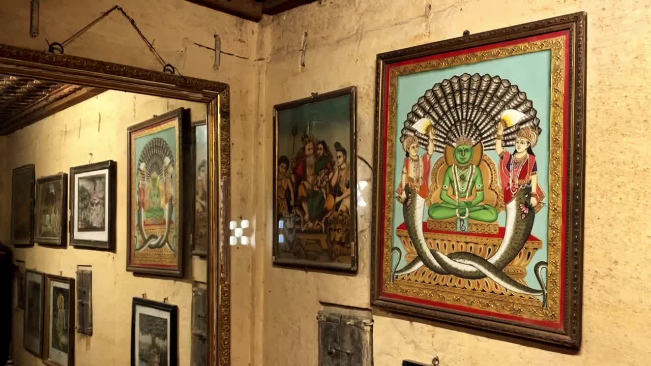 Tilt down shot of interior view of the photo frames collection hanging on wall Kothari's Patwon Ki Haveli or Patwa Haveli Jaisalmer India 4K