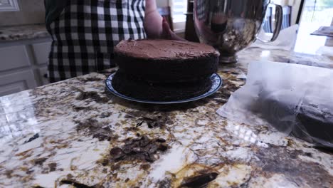 Frosting-a-three-layer-chocolate-cake---isolated-close-up