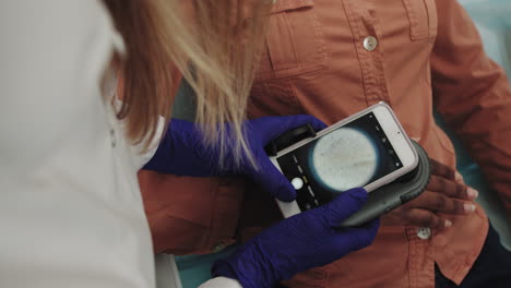 doctor performing skin examination with smartphone