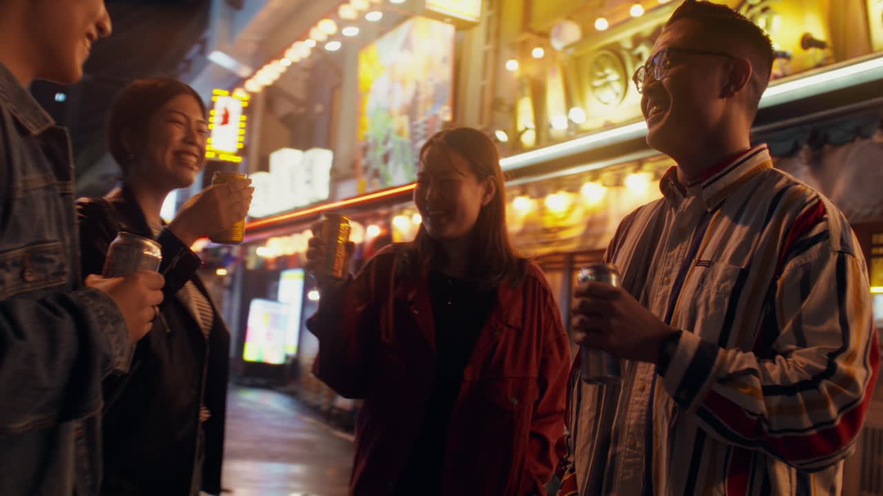 Friends enjoying drinks in a Japanese night city