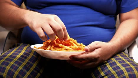 person eating a large pile of french fries