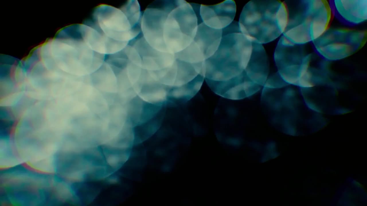 Abstract Blue Bokeh Lights Moving on Dark Background