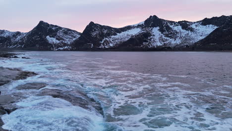majestic winter coastline at tungeneset, norway, with waves crashing on rocky shore