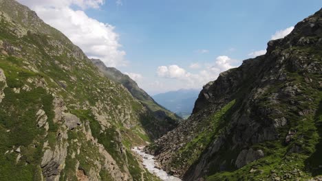 wide angle drone video of the beautiful mountains in northern italy with a giant waterfall and river. near the dolomites in south tyrol.