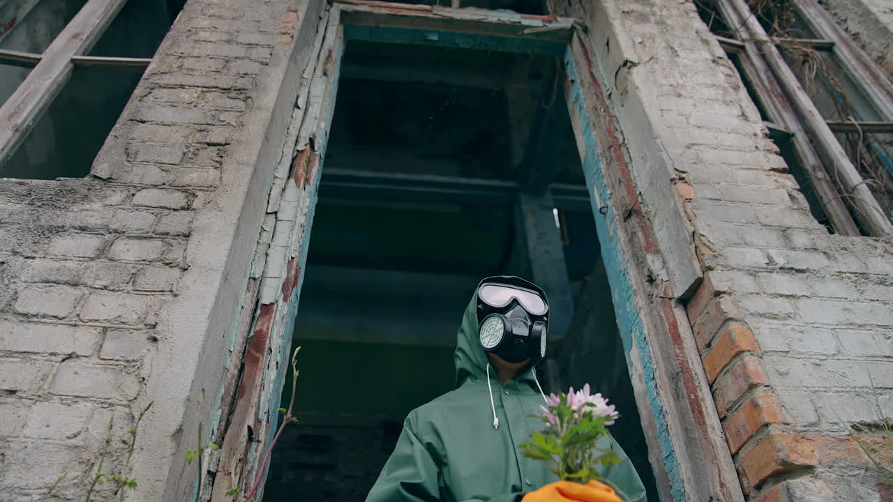 Sopravvissuto dopo una guerra nucleare chimica. Stalker con maschera antigas che cammina lungo una fabbrica abbandonata.
