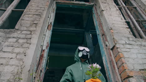 survivor after nuclear chemical war. stalker in gas mask walking along abandoned factory