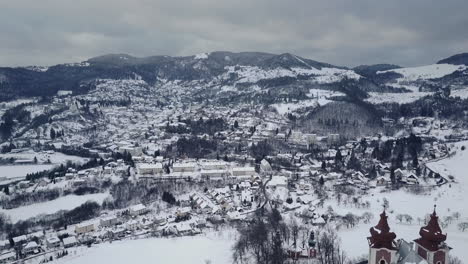 flying towards old mining town banska stiavnica above calvary church, winter