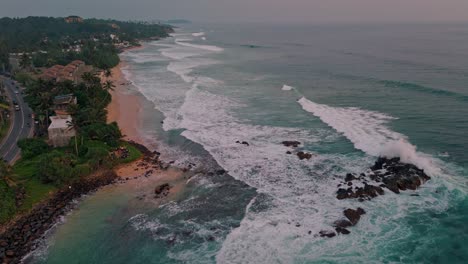 stunning aerial footage capturing the golden hues of sunset over the weligama coastline in sri lanka.