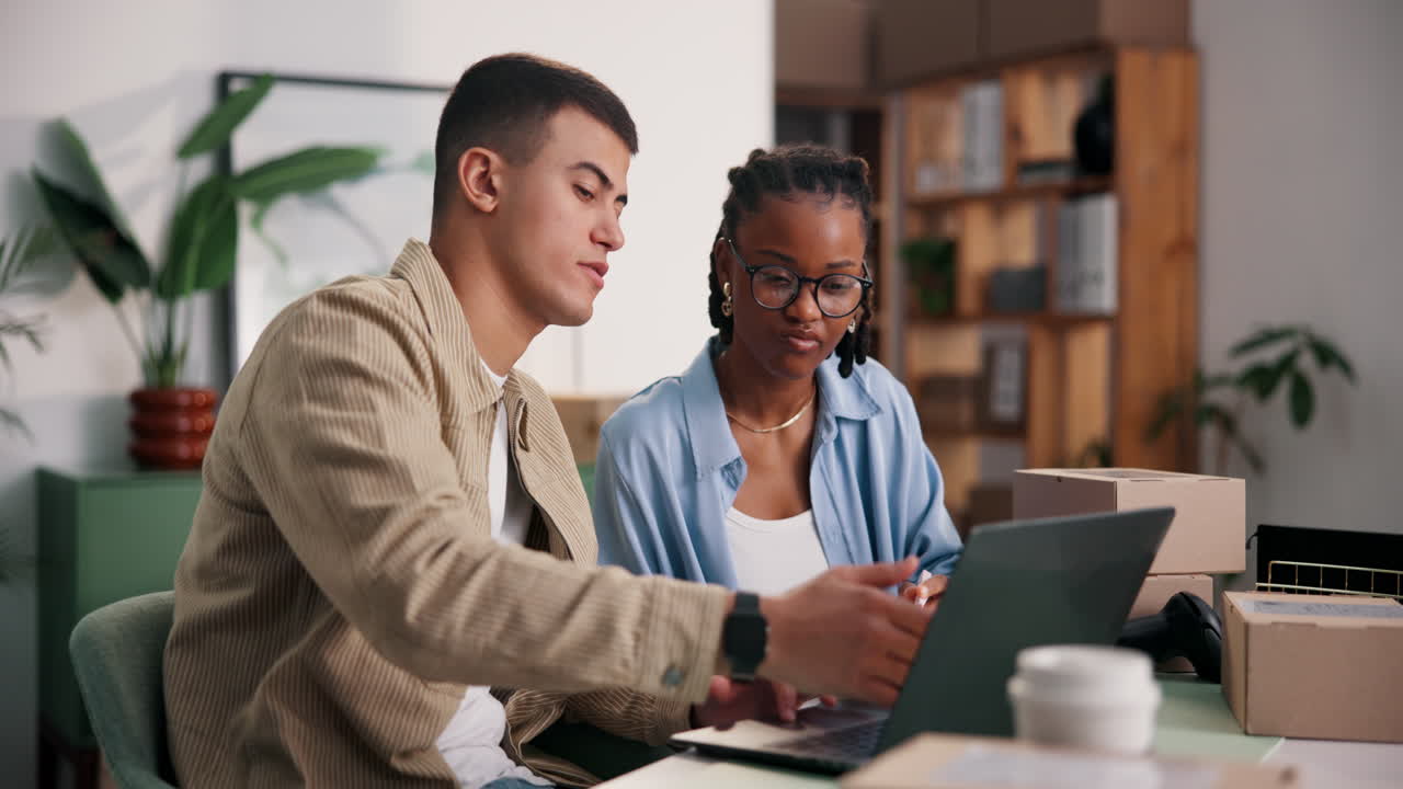 Two colleagues working together on a laptop