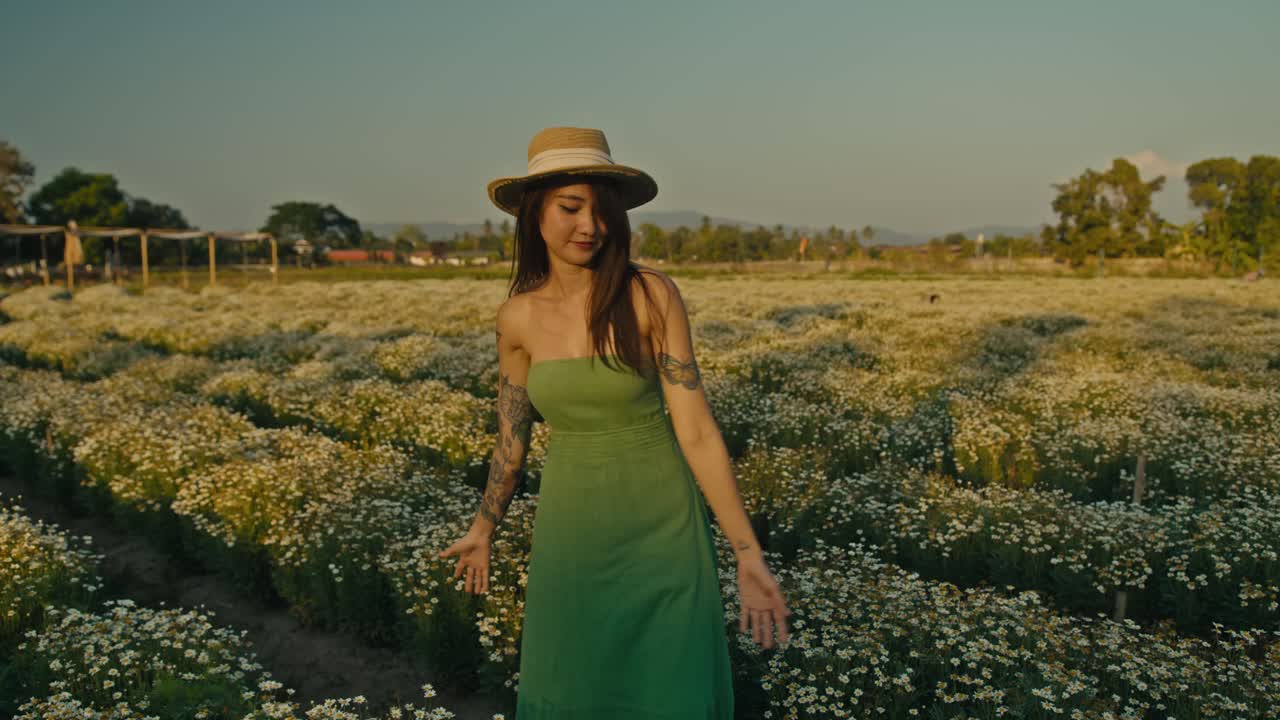 Woman enjoying the sunset in a flower field
