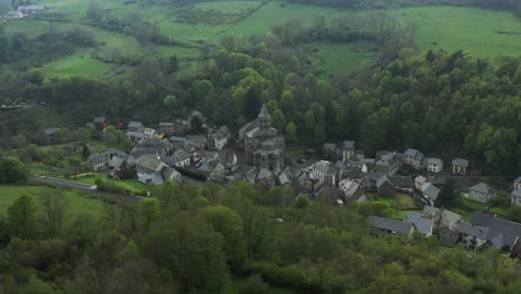 Charming-village-in-vibrant-green-valley-with-a-stunning-church