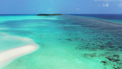 large turquoise lagoon with coral reef and pebbles under clear water around tiny tropical island on a bright sky background in seychelles