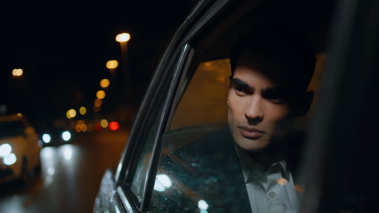 Elegant entrepreneur looking window at rainy evening closeup. Manager riding car