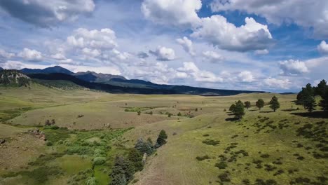 aerial: drone ascending higher to reveal more of this open valley