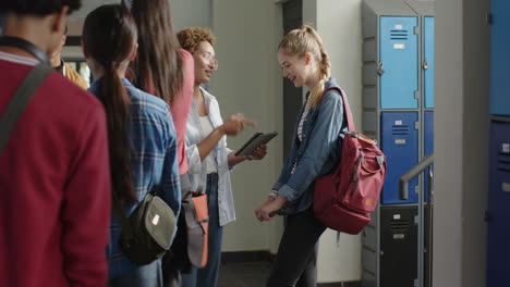 In high school, teenage girl with backpack smiling and talking with friends near lockers