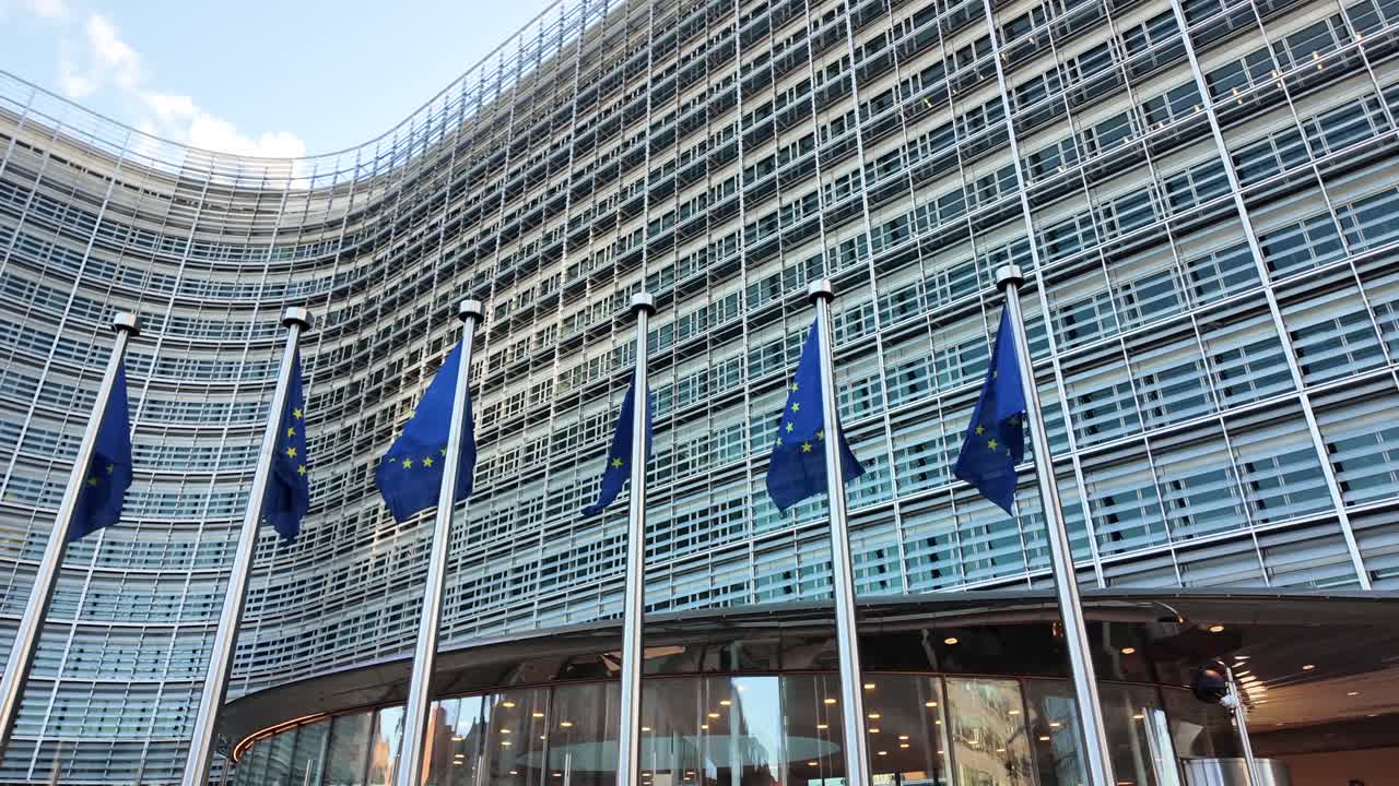 Berlaymont facade with European Union flags fluttering in the wind