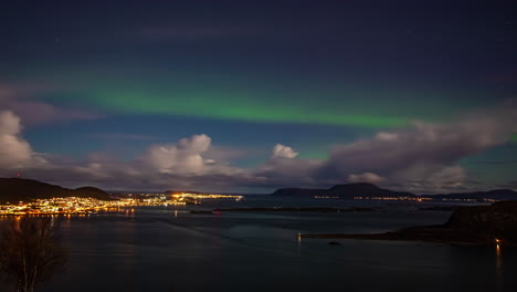 static shot of northern lights over alesund town in more og romsdal, norway at night time in timelapse