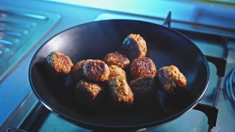 plating hot fried meatballs in the kitchen