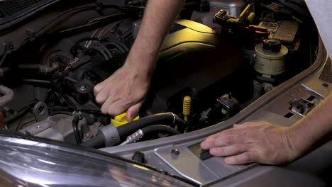 removing the oil cap on the car engine