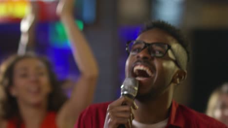 happy black man singing karaoke