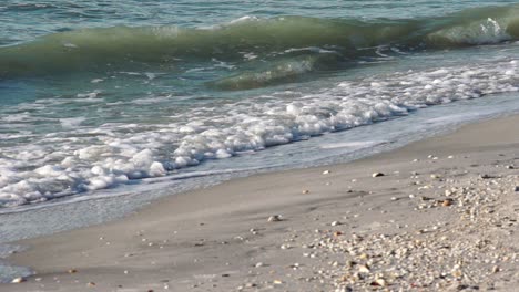 slow motion gentle gulf waves in soft sunlight on white sandy beach in boca grande