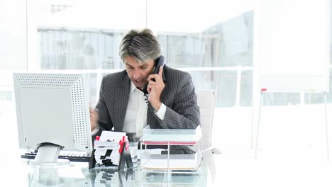 Lucky-businessman-on-phone-celebrating-a-success