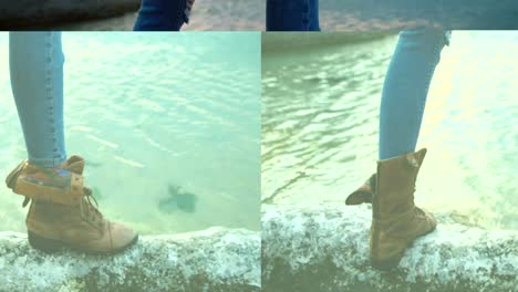 woman standing on rock at beach 4k