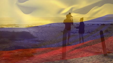 Animación-De-La-Bandera-De-Colombia-Sobre-Padres-Caucásicos-Con-Un-Niño-En-La-Playa