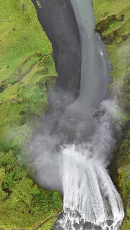 top-down, slow motion aerial view of going over the seljalandsfoss waterfalls in iceland