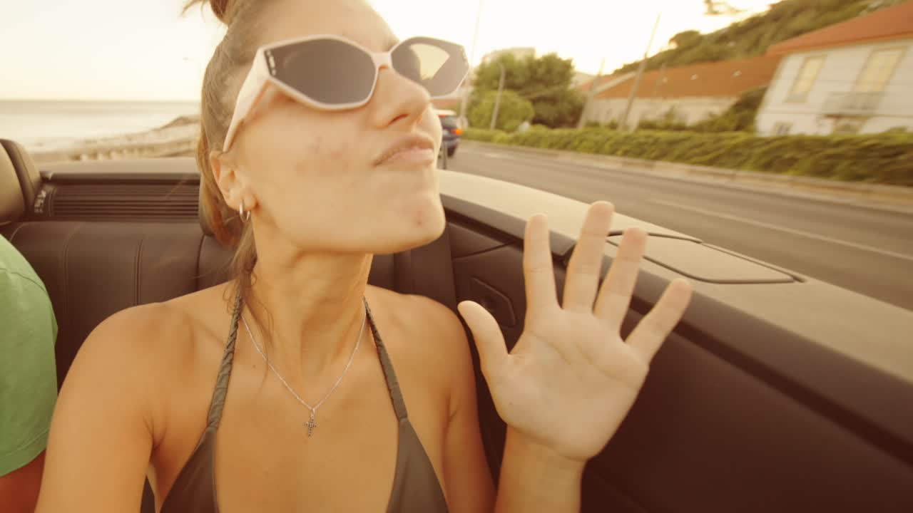 Woman enjoying a road trip in a convertible