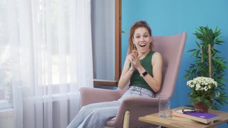 Woman-giving-congratulatory-message-to-camera-applauding.