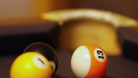 billiard balls in motion on a pool table - close up