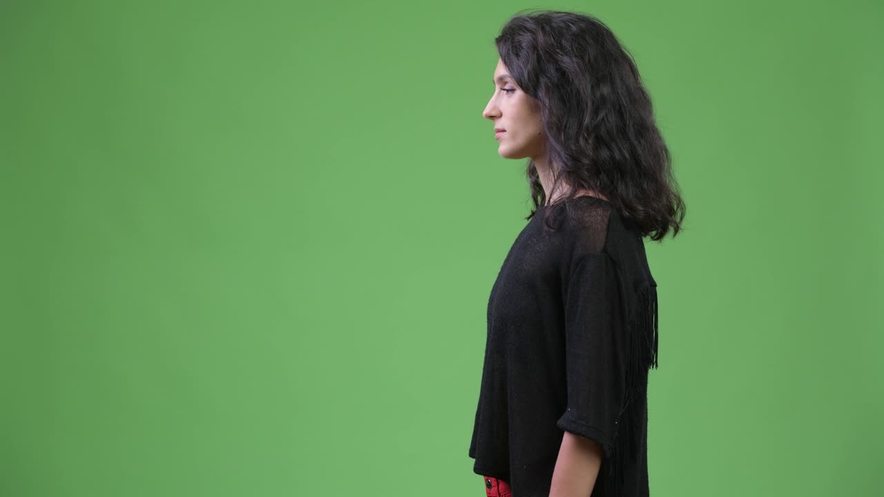 Profile view of young beautiful woman with long wavy hair