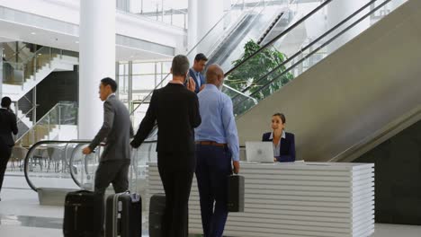 business people showing mobile phone at reception 4k