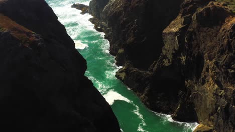 aerial view of dramatic rocky coastline and turbulent ocean