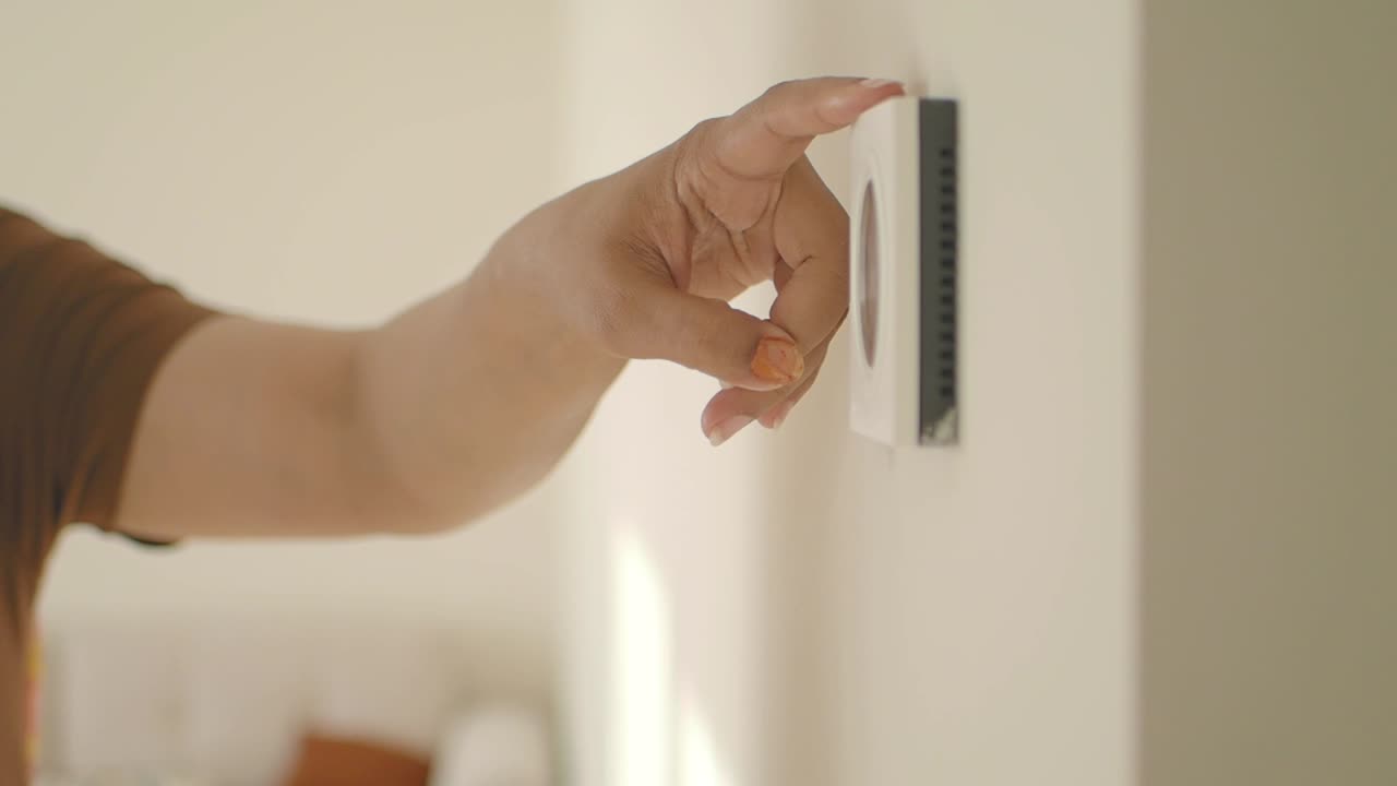 Person installing a wall thermostat