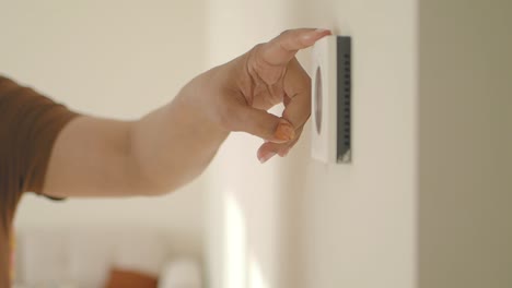 person installing a wall thermostat