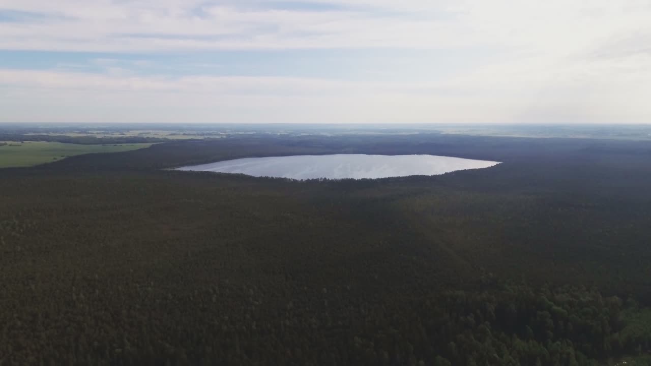 Eye Shape Silhouette Lake Surrounded By Forest. Aerial Fast Pedestal-Up Shot