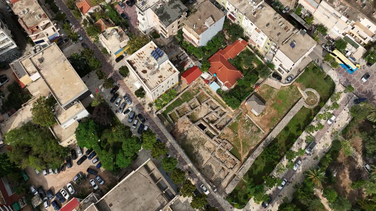 Aerial: cityscape, real estate and buildings during the day in Sarande, Albania, establishing drone shot