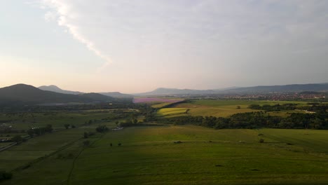 Aerial-view-of-Hungarian-countryside-with-mountains-and-village-in-background