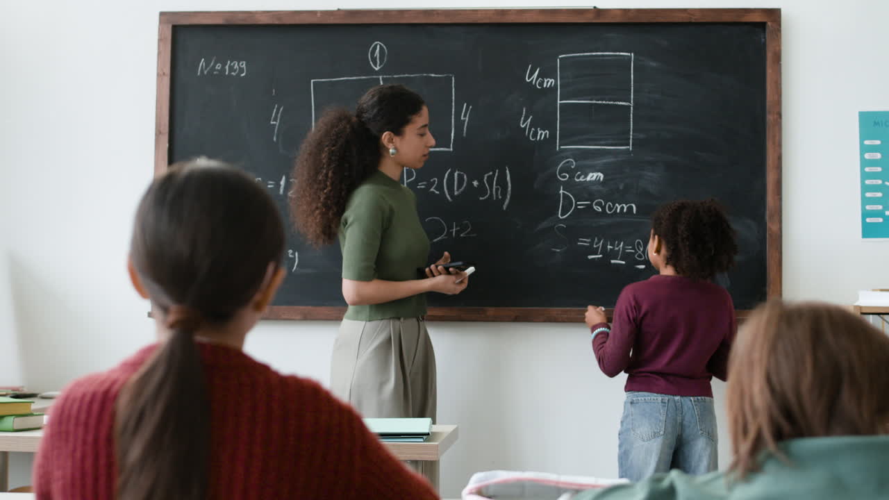 Teacher teaching math to students in classroom