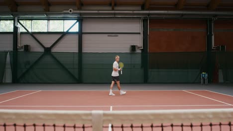 man playing tennis indoor