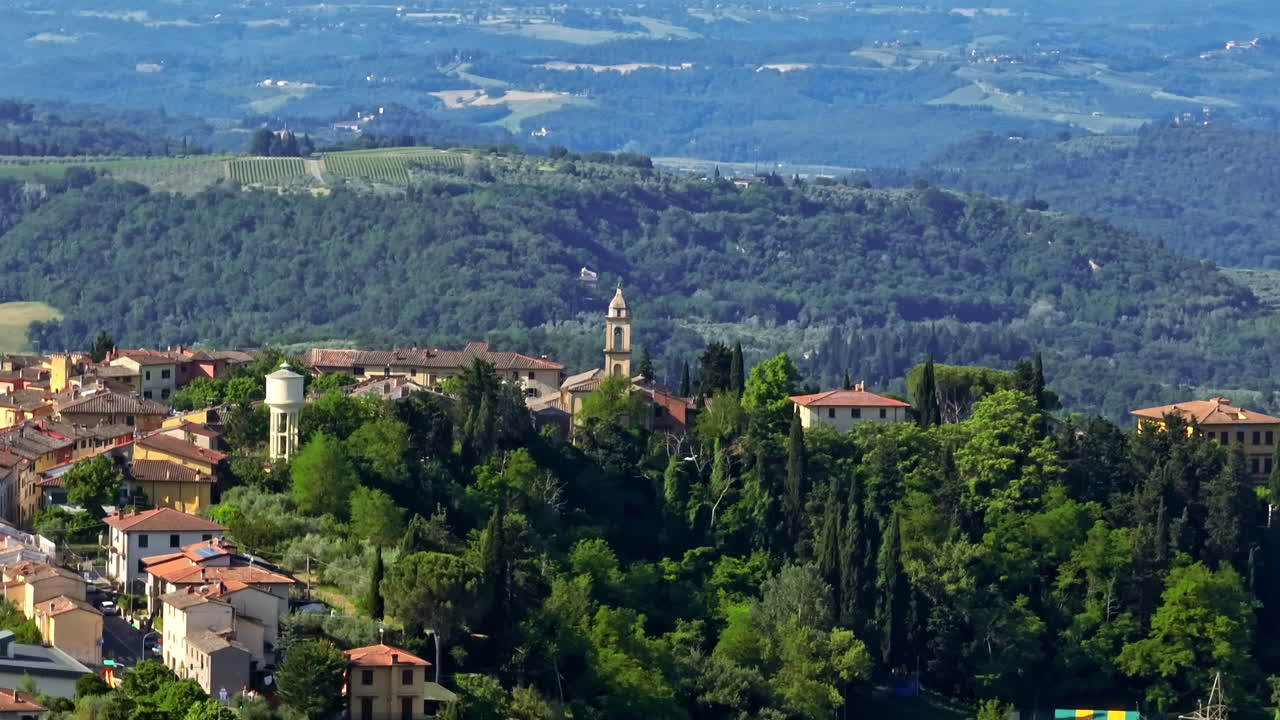 Telephoto drone parallax of the Marcialla village, summer day in Tuscany, Italy