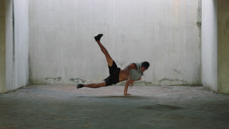 Hombre-Bailando-Joven-Talentoso-Bailarín-Callejero-Breakdance-Realizando-Varios-Movimientos-De-Baile-De-Estilo-Libre-En-Forma-De-Hombre-De-Raza-Mixta-Practicando-En-Un-Almacén-Sucio