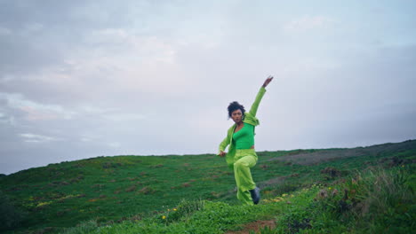 passionate girl artist dancing on evening field. dancer performing vertical