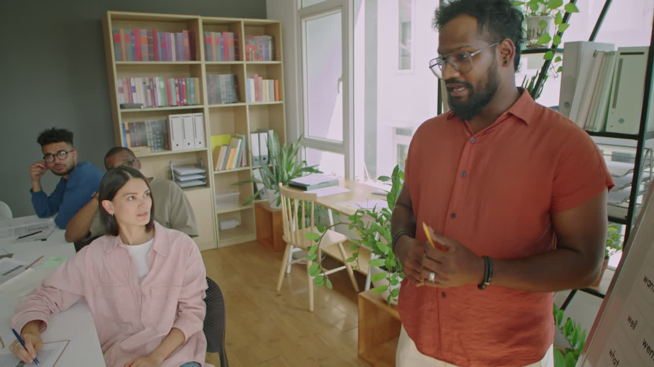 Multiracial Teacher Giving Lesson to Immigrant Students